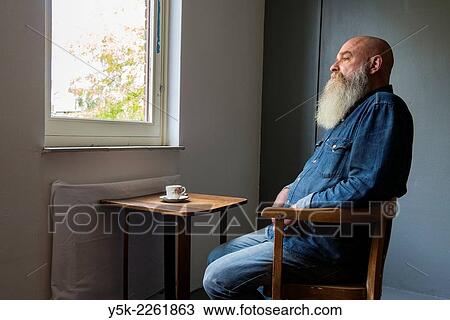 Tilburg, Netherlands. Portrait of a bald man with beard, drinking a cup of coffee while looking out the window. View Large Photo Image Stock Image - Tilburg, Netherlands. Portrait of a bald man with beard, drinking a cup of coffee while looking out the window.. Fotosearch