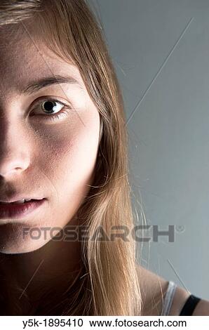 Tilburg, Netherlands. Studio-portrait of a young woman against a grey background. Detailed image. View Large Photo Image Stock Image - Tilburg, Netherlands. Studio-portrait of a young woman against a grey background. Detailed image.. Fotosearch