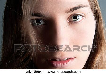 Tilburg, Netherlands. Studio-portrait of a young woman against a grey background. Detailed image, enhanced. View Large Photo Image Stock Image - Tilburg, Netherlands. Studio-portrait of a young woman against a grey background. Detailed image, enhanced.. Fotosearch
