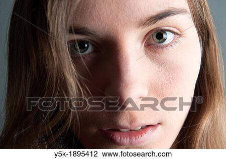 Tilburg, Netherlands. Studio-portrait of a young woman against a grey background. Detailed image. View Large Photo Image Stock Image - Tilburg, Netherlands. Studio-portrait of a young woman against a grey background. Detailed image.. Fotosearch