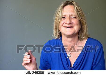 Tilburg, Netherlands. Studio portrait of a middle aged woman smoking a cigarette. View Large Photo Image Stock Image - Tilburg, Netherlands. Studio portrait of a middle aged woman smoking a cigarette.. Fotosearch