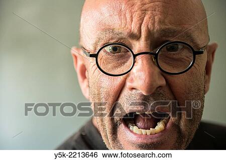 Tilburg, Netherlands. Studio-portrait of a bald, be glassed and middle-aged man, talking, speaking and telling a story. View Large Photo Image Stock Photograph - Tilburg, Netherlands. Studio-portrait of a bald, be glassed and middle-aged man, talking, speaking and telling a story.. Fotosearch
