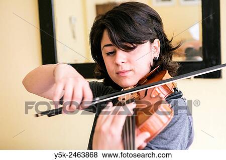 Stock Photo - Tilburg, Netherlands. Young Italian violinist practising and rehearsing, in preparation of her conservatoire exam.. Fotosearch