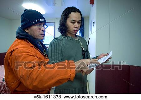 Two Indonesian sailors, known as: ´Able Seamen´ are reviewing the loading-manifest for the loading and unloading of containers in the harbor of Stockholm, Sweden. The vessel is making a voyage from Rotterdam, Netherlands, to Sundsvall, Sweden. View Large Photo Image Stock Photo - Two Indonesian sailors, known as: ´Able Seamen´ are reviewing the loading-manifest for the loading and unloading of containers in the harbor of Stockholm, Sweden. The vessel is making a voyage from Rotterdam, Netherlands, to Sundsvall, Sweden.. Fotosearch