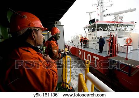 Two indonesian Seamen or sailors on the container-vessel MV Flintercape, during a journey from Rotterdam, Netherlands, to Sundsvall, Sweden. The men are ´Able Seaman´, who generally work on deck, and now and are now ready to welcome the Pilot on board. View Large Photo Image Stock Image - Two indonesian Seamen or sailors on the container-vessel MV Flintercape, during a journey from Rotterdam, Netherlands, to Sundsvall, Sweden. The men are ´Able Seaman´, who generally work on deck, and now and are now ready to welcome the Pilot on board.. Fotosearch
