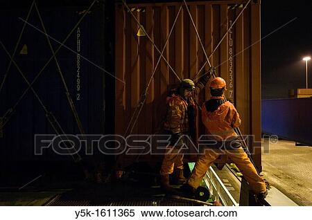 Two ´Able Seamen´ or sailors are receiving and placing new containers on the deck of container-vessel MV Flintercape, who sails from Rotterdam, Netherlands to Sundsvall, Sweden. The men are both Indonesian men. View Large Photo Image Stock Photography - Two ´Able Seamen´ or sailors are receiving and placing new containers on the deck of container-vessel MV Flintercape, who sails from Rotterdam, Netherlands to Sundsvall, Sweden. The men are both Indonesian men.. Fotosearch