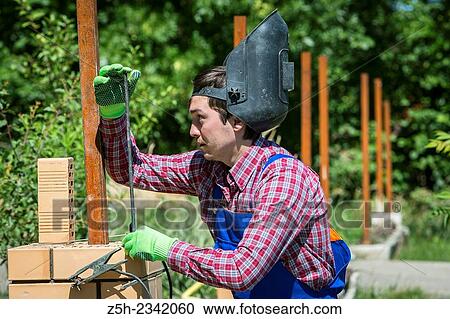Welder assembly of individual houses. View Large Photo Image Stock Image - Welder assembly of individual houses.. Fotosearch