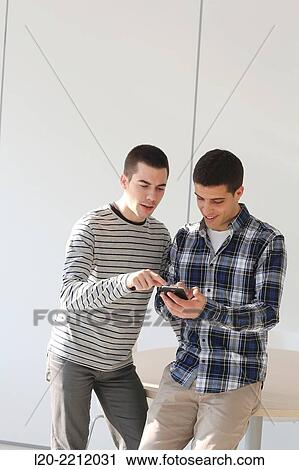 Stock Image - Young students at campus. Fotosearch