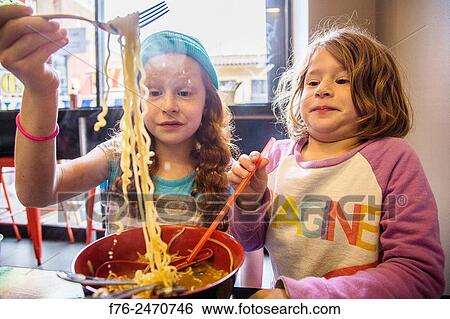 10 year old girl with woolen cap on and her 6 year old sister,, eating noodles in a noodle restaurant in Berkeley, CA, MR# 6063. View Large Photo Image Stock Photograph - 10 year old girl with woolen cap on and her 6 year old sister,, eating noodles in a noodle restaurant in Berkeley, CA, MR# 6063.. Fotosearch