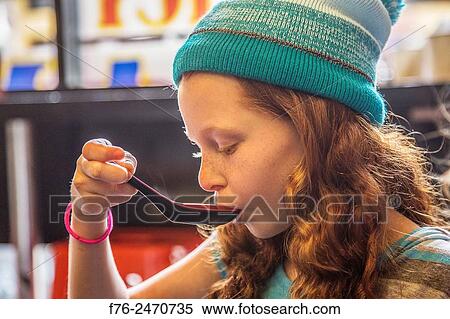 10 year old girl with woolen cap on, eating noodles in a noodle restaurant in Berkeley, CA, MR# 6063. View Large Photo Image Stock Photography - 10 year old girl with woolen cap on, eating noodles in a noodle restaurant in Berkeley, CA, MR# 6063.. Fotosearch