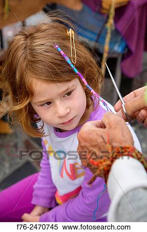 6 year old girl having a street vendor weave a threaded braid in her hair in Berkeley, CA, MR 6063. View Large Photo Image Stock Photography - 6 year old girl having a street vendor weave a threaded braid in her hair in Berkeley, CA, MR 6063.. Fotosearch