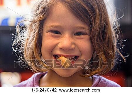 6 year old girl with a cooked shrimp in her mouth in a noodle restaurant in Berkeley, CA, MR# 6063. View Large Photo Image Stock Image - 6 year old girl with a cooked shrimp in her mouth in a noodle restaurant in Berkeley, CA, MR# 6063.. Fotosearch