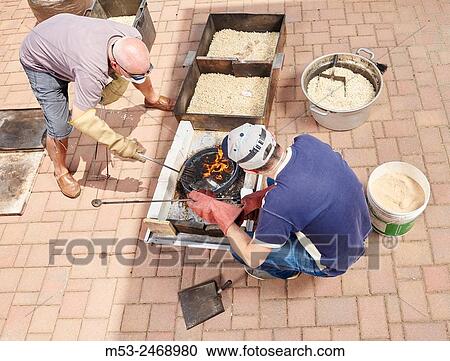 A raku master brush a ceramic object after the heating process. Bovisio Masciago. Province of Monza and Brianza. lombardy. Italy. View Large Photo Image Stock Image - A raku master brush a ceramic object after the heating process. Bovisio Masciago. Province of Monza and Brianza. lombardy. Italy.. Fotosearch
