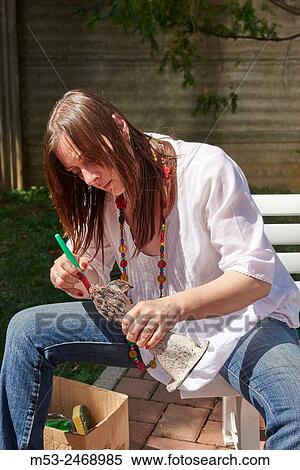 A woman wash and clean from debris her piece of raku ceramics after the firing process. Bovisio Masciago. Province of Monza and Brianza. Lombardy. Italy. View Large Photo Image Stock Photography - A woman wash and clean from debris her piece of raku ceramics after the firing process. Bovisio Masciago. Province of Monza and Brianza. Lombardy. Italy.. Fotosearch