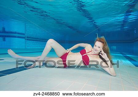 A young woman under water in a swimming bath. View Large Photo Image Stock Image - A young woman under water in a swimming bath.. Fotosearch