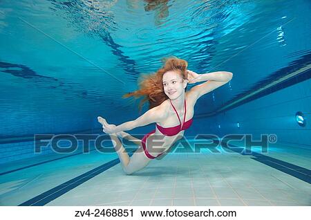 A young woman under water in a swimming bath. View Large Photo Image Stock Image - A young woman under water in a swimming bath.. Fotosearch