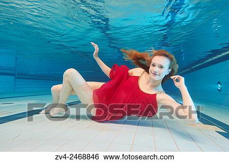 A young woman under water in a swimming bath. View Large Photo Image Stock Photograph - A young woman under water in a swimming bath.. Fotosearch