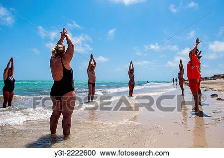 Africa, North Africa, Maghreb, South Tunisia, Governorat of Medenine. Djerba island. Tourists doing gymnastics on the beach of Sidi Mehres. View Large Photo Image Stock Image - Africa, North Africa, Maghreb, South Tunisia, Governorat of Medenine. Djerba island. Tourists doing gymnastics on the beach of Sidi Mehres.. Fotosearch