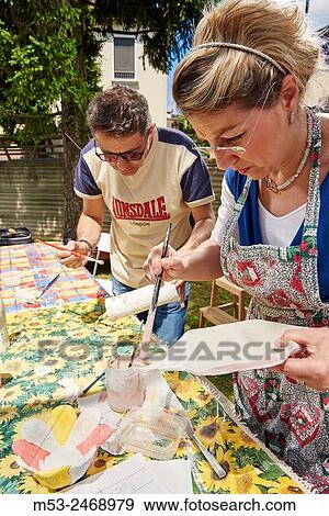 Amateur artista apply raku glaze on ceramic objects. View Large Photo Image Stock Photo - Amateur artista apply raku glaze on ceramic objects.. Fotosearch