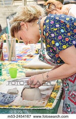 Amateur artists while modeling clay to obtain raku ceramics. View Large Photo Image Stock Photo - Amateur artists while modeling clay to obtain raku ceramics.. Fotosearch