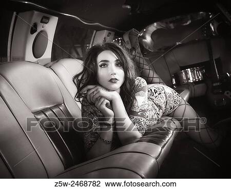 Attractive brunette girl posing inside the limousine, tinted black and white image. View Large Photo Image Stock Image - Attractive brunette girl posing inside the limousine, tinted black and white image.. Fotosearch