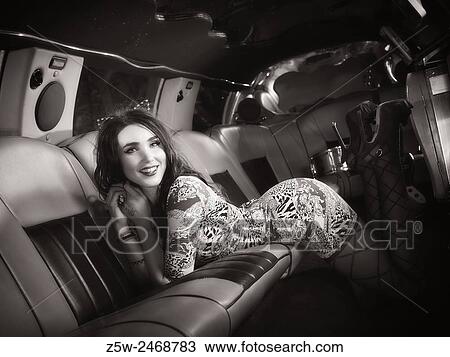 Attractive brunette girl posing inside the limousine, tinted black and white image. View Large Photo Image Stock Image - Attractive brunette girl posing inside the limousine, tinted black and white image.. Fotosearch