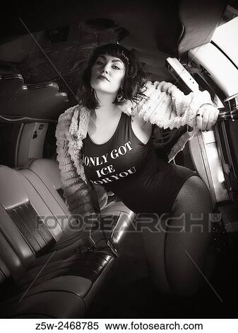 Attractive brunette girl posing inside the limousine, tinted black and white image. View Large Photo Image Stock Photography - Attractive brunette girl posing inside the limousine, tinted black and white image.. Fotosearch
