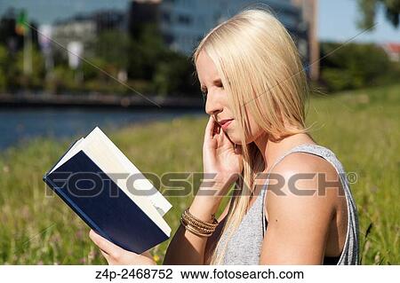 Blond woman reading a book View Large Photo Image Stock Image - Blond woman reading a book. Fotosearch