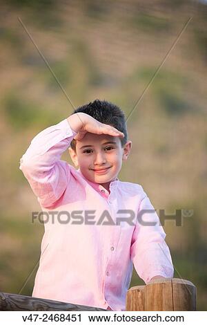 Boy posing for camera eye shadow by hand View Large Photo Image Stock Image - Boy posing for camera eye shadow by hand. Fotosearch