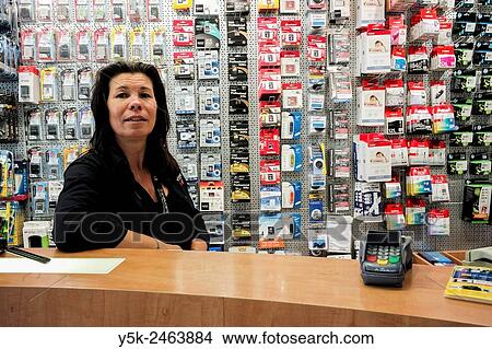 Breda, Netherlands. Female employee of a photo store standing behind the shop´s counter. View Large Photo Image Picture - Breda, Netherlands. Female employee of a photo store standing behind the shop´s counter.. Fotosearch