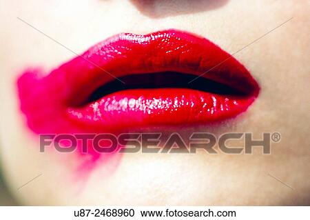 Stock Image - Close up of woman mouth with smudged lipstick... Fotosearch