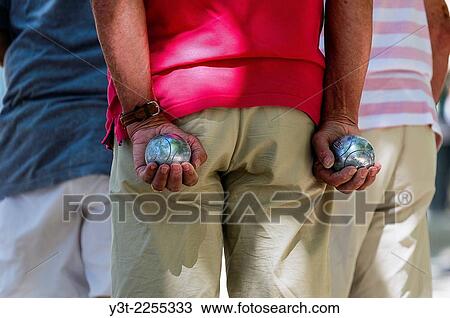 Europe, France, Var, Saint-Tropez. Place des lices. Man Playing petanque. View Large Photo Image Stock Image - Europe, France, Var, Saint-Tropez. Place des lices. Man Playing petanque.. Fotosearch