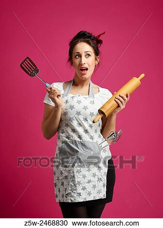 Funny housewife and kitchen utensils, pink background. View Large Photo Image Stock Image - Funny housewife and kitchen utensils, pink background.. Fotosearch