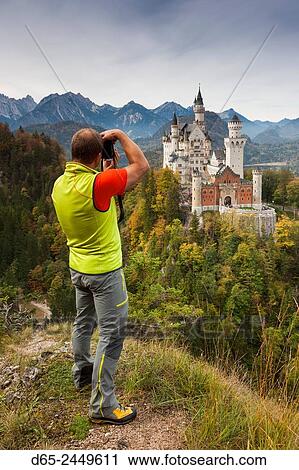 Germany, Bavaria, Hohenschwangau, Schloss Neuschwanstein castle and photographer, elevated view, R. View Large Photo Image Stock Image - Germany, Bavaria, Hohenschwangau, Schloss Neuschwanstein castle and photographer, elevated view, R.. Fotosearch