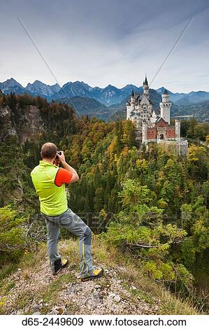 Germany, Bavaria, Hohenschwangau, Schloss Neuschwanstein castle and photographer, elevated view, R. View Large Photo Image Stock Photo - Germany, Bavaria, Hohenschwangau, Schloss Neuschwanstein castle and photographer, elevated view, R.. Fotosearch