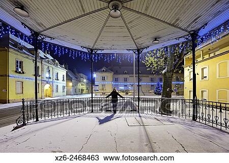 Girl at night in a bandstand at Christmas with snow, Louhans, Saône-et-Loire, Bourgogne, France, Europe. View Large Photo Image Stock Image - Girl at night in a bandstand at Christmas with snow, Louhans, Saône-et-Loire, Bourgogne, France, Europe.. Fotosearch