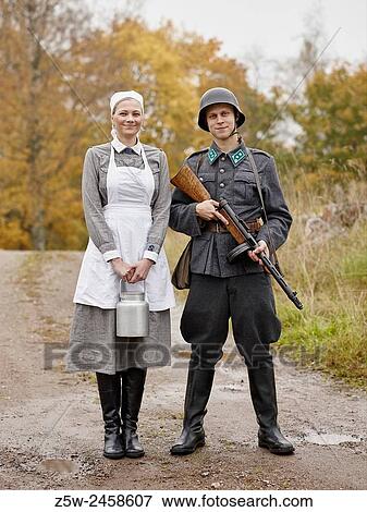 Stock Photo - Historic costume theme World War II, Finnish soldier and the Lotta. Photographed in the Ragvalds museum area in Kirkkonummi, Finland.. Fotosearch
