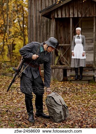 Stock Photo - Historic costume theme World War II, Finnish soldier and the Lotta. Photographed in the Ragvalds museum area in Kirkkonummi, Finland.. Fotosearch