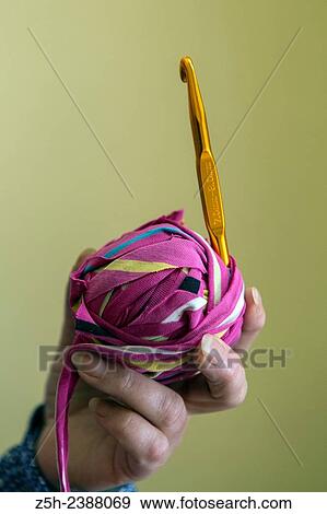 Stock Photo - Knitting rugs from old cloth at home. Russia. Belgorod region.. Fotosearch