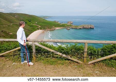 Man at the viewpoint over Torimbia beach. Niembro, Asturias province, Spain. View Large Photo Image Stock Image - Man at the viewpoint over Torimbia beach. Niembro, Asturias province, Spain.. Fotosearch
