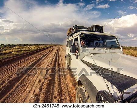 , Namibia, Africa - Land Rover Defender 110 driving down dirt road at sunset. View Large Photo Image Stock Photography - , Namibia, Africa - Land Rover Defender 110 driving down dirt road at sunset.. Fotosearch