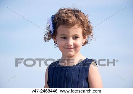 Portrait of a girl with a bow in her hair View Large Photo Image Stock Photograph - Portrait of a girl with a bow in her hair. Fotosearch