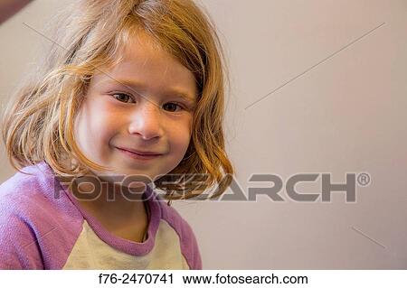 Stock Image - Smiling portrait of 6 year old girl looking at camera, in Berkeley, CA. MR# 6063. Fotosearch