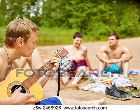 The group of the friends chilling out on the beach, summer day. Shot in southern Finland. View Large Photo Image Stock Photograph - The group of the friends chilling out on the beach, summer day. Shot in southern Finland.. Fotosearch