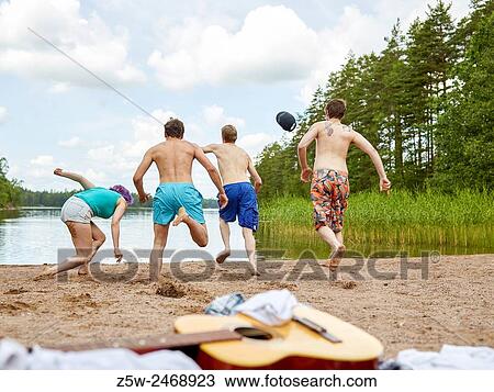 The group of the people runs in the lake, summer day. Shot in southern Finland. View Large Photo Image Stock Image - The group of the people runs in the lake, summer day. Shot in southern Finland.. Fotosearch