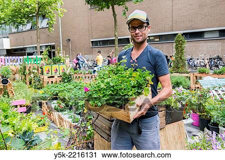 Tilburg, Netherlands. Bram is an Urban Gardener, maintaining his urban kitchen garden down town Tilburg. View Large Photo Image Stock Image - Tilburg, Netherlands. Bram is an Urban Gardener, maintaining his urban kitchen garden down town Tilburg.. Fotosearch