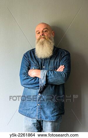 Tilburg, Netherlands. Portrait of a bald man with beard, standing against a grey wall. View Large Photo Image Picture - Tilburg, Netherlands. Portrait of a bald man with beard, standing against a grey wall.. Fotosearch
