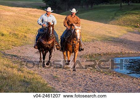 Two wranglers Cowboys on horses, riding near a pond, California, USA View Large Photo Image Stock Photo - Two wranglers Cowboys on horses, riding near a pond, California, USA. Fotosearch