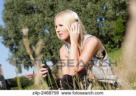 Woman listening concentrated to music. View Large Photo Image Stock Photo - Woman listening concentrated to music.. Fotosearch