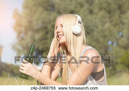 Woman listening to music View Large Photo Image Stock Photography - Woman listening to music. Fotosearch